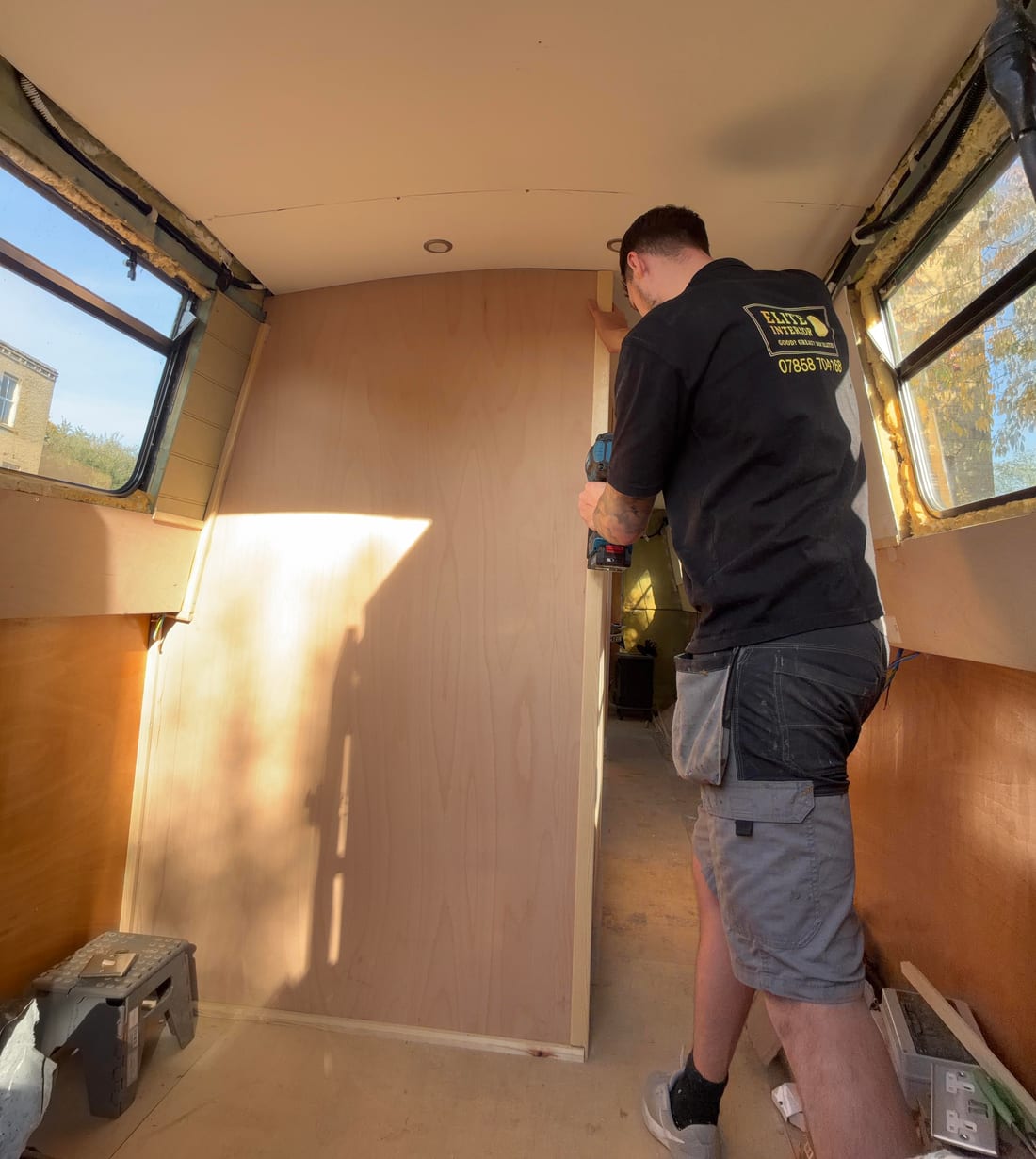 Rory from Elite Interior fitting bespoke plywood panelling